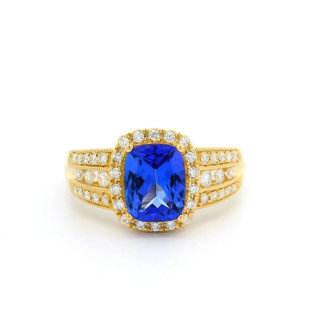 14k Yellow Gold 2.27ctw Cushion Tanzanite Diamond Cocktail Ring: 14k Yellow Gold 2.27ctw Cushion Tanzanite Diamond Cocktail Ring This exquisite cocktail ring features a stunning 1.76ct cushion-cut tanzanite set in solid 14k yellow gold, complemented by a total of 0