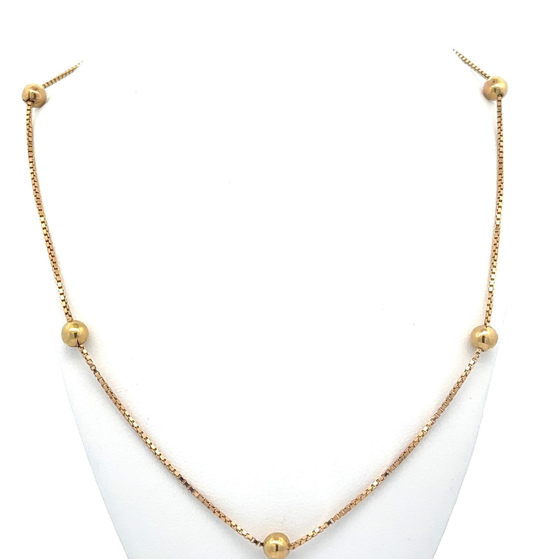 19.5 Inch 14k Yellow Gold Box Chain Necklace With Bead Ball Stations: 19.5 Inch 14k Yellow Gold Box Chain Necklace With Bead Ball Stations This vintage chain necklace features solid 14k yellow gold construction. It is designed with a 19.5-inch box link chain accented by