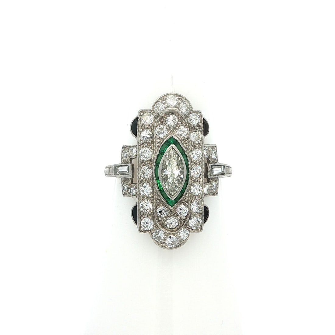 Art Deco Platinum 1.25ctw Diamond & Green Stones Shield Ring: Art Deco Platinum 1.25ctw Diamond & Green Stones Shield Ring This exquisite Art Deco dinner ring showcases a unique shield design, crafted in solid platinum with an impressive total carat weight of 1.