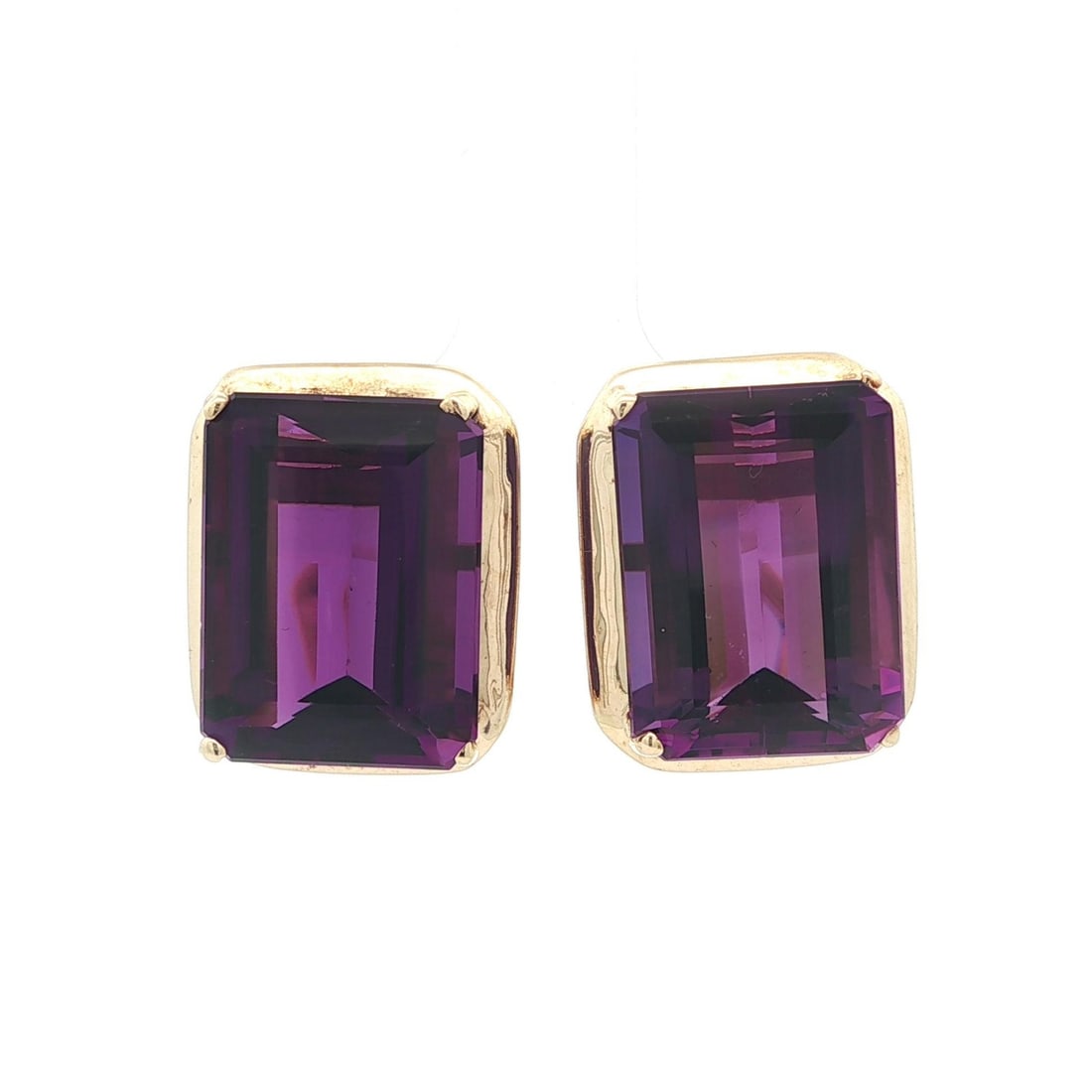 16ctw Emerald Cut Amethyst Stud Earrings in Yellow Gold with Omega Closures: 16ctw Emerald Cut Amethyst Stud Earrings in Yellow Gold with Omega Closures These stud earrings feature two natural emerald cut amethysts with a deep rich purple color, totaling approximately 16 carat