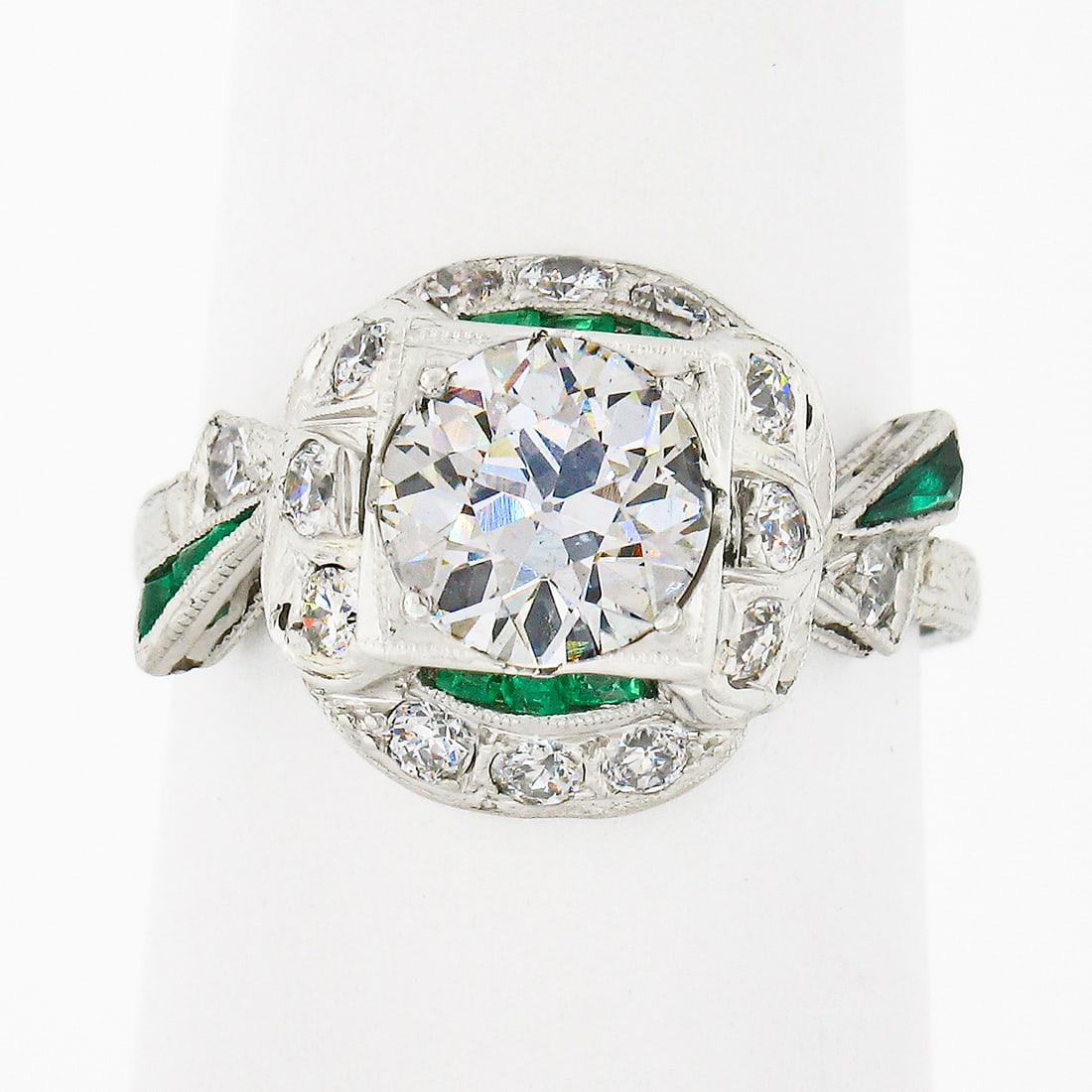 Antique Art Deco Platinum Engagement Ring with Diamond and Emerald Ribbons: Antique Art Deco Platinum Engagement Ring with Diamond and Emerald Ribbons This exquisite Antique Art Deco engagement ring is a stunning piece crafted from solid platinum, dating back to the early Art