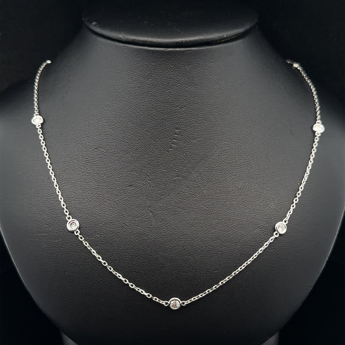 10 Diamond Station Chain Necklace in 14k White Gold 0.70ctw By The Yard 18 Inch: 10 Diamond Station Chain Necklace in 14k White Gold 0.70ctw By The Yard 18 Inch This un-used chain necklace features ten round brilliant cut natural white diamonds, bezel set along a by the yard cable