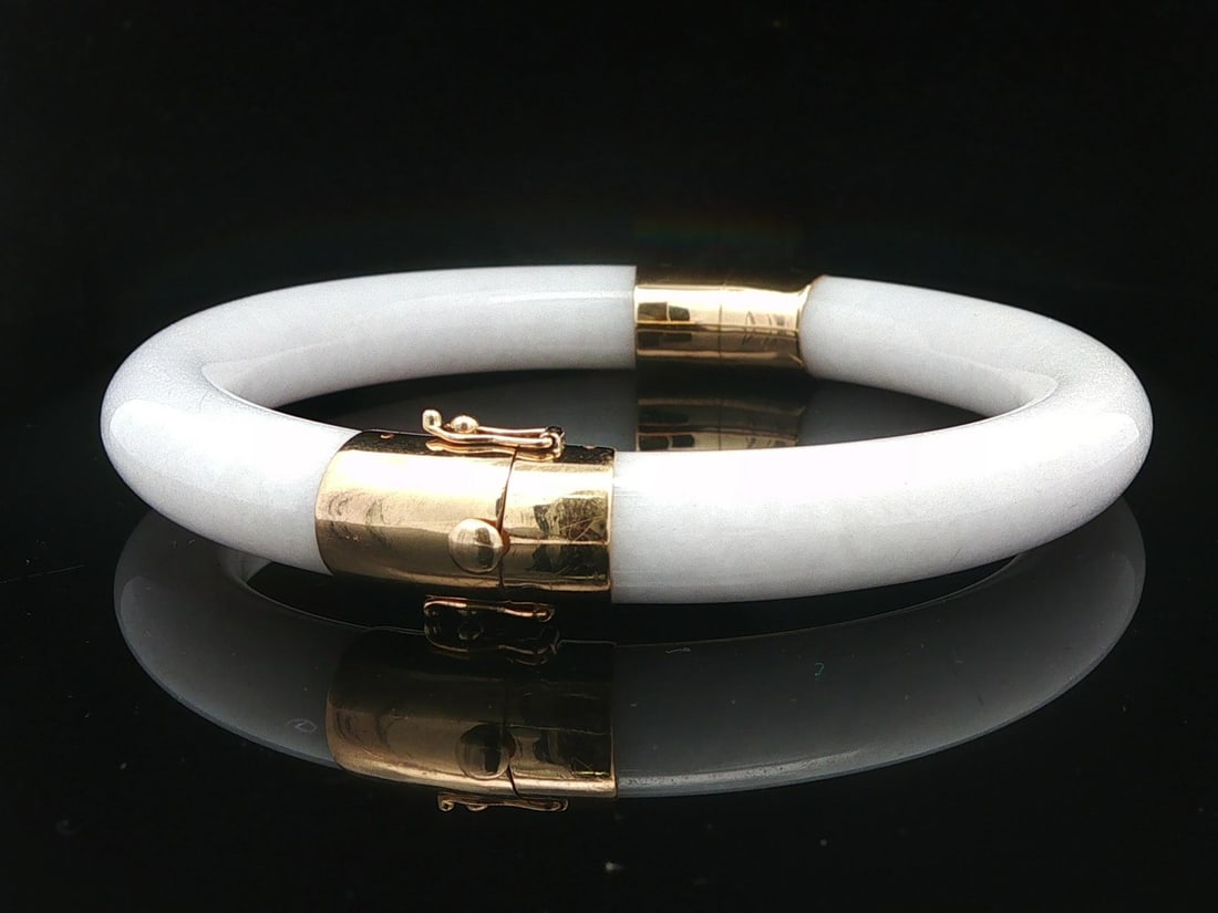 Gump's 14k Yellow Gold White Fei Cui Jade Hinged Bangle GIA Certified: Gump's 14k Yellow Gold White Fei Cui Jade Hinged Bangle GIA Certified This vintage Gump's bangle bracelet features two natural, certified Type A Fei Cui jade segments in an arc shape with a translucen