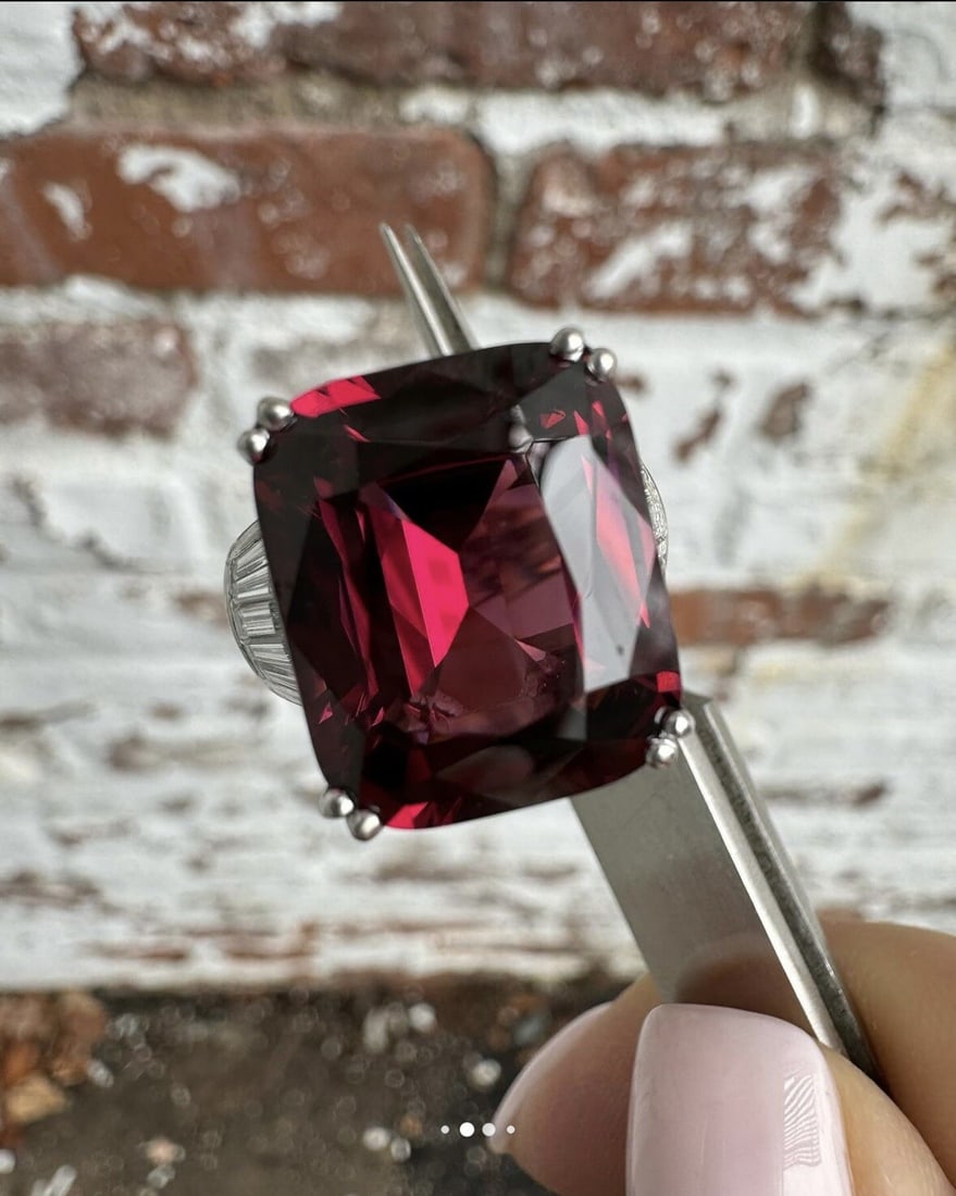 GIA 14.50ctw Platinum Rhodolite Garnet Diamond Accents Solitaire Ring: GIA 14.50ctw Platinum Rhodolite Garnet Diamond Accents Solitaire Ring Presenting a stunning Platinum ring featuring a 14.50 carat total weight, adorned with a captivating Cushion Rhodolite Garnet and 
