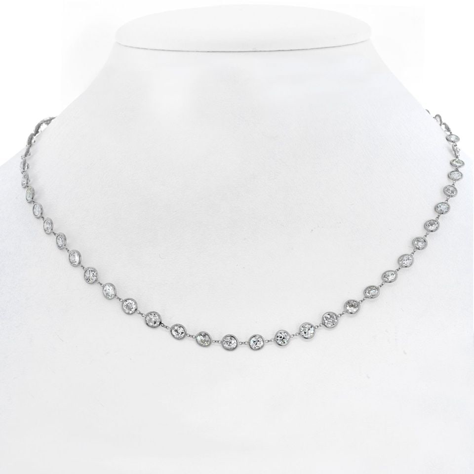 Platinum 13.50ct Round Cut Diamonds By The Yard Necklace: Platinum 13.50ct Round Cut Diamonds By The Yard Necklace This exquisite necklace features a stunning array of round cut diamonds, totaling approximately 13.50 carats, elegantly set in a platinum by-th