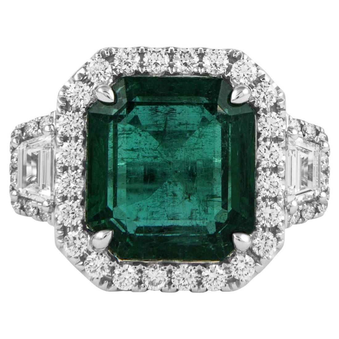 7.57ct Emerald Diamond 3-Stone Ring 18k White Gold GIA Certified: 7.57ct Emerald Diamond 3-Stone Ring 18k White Gold GIA Certified This exquisite 3-stone ring features a stunning 7.57 ct emerald cut emerald at its center, surrounded by a halo of diamonds. Crafted fr