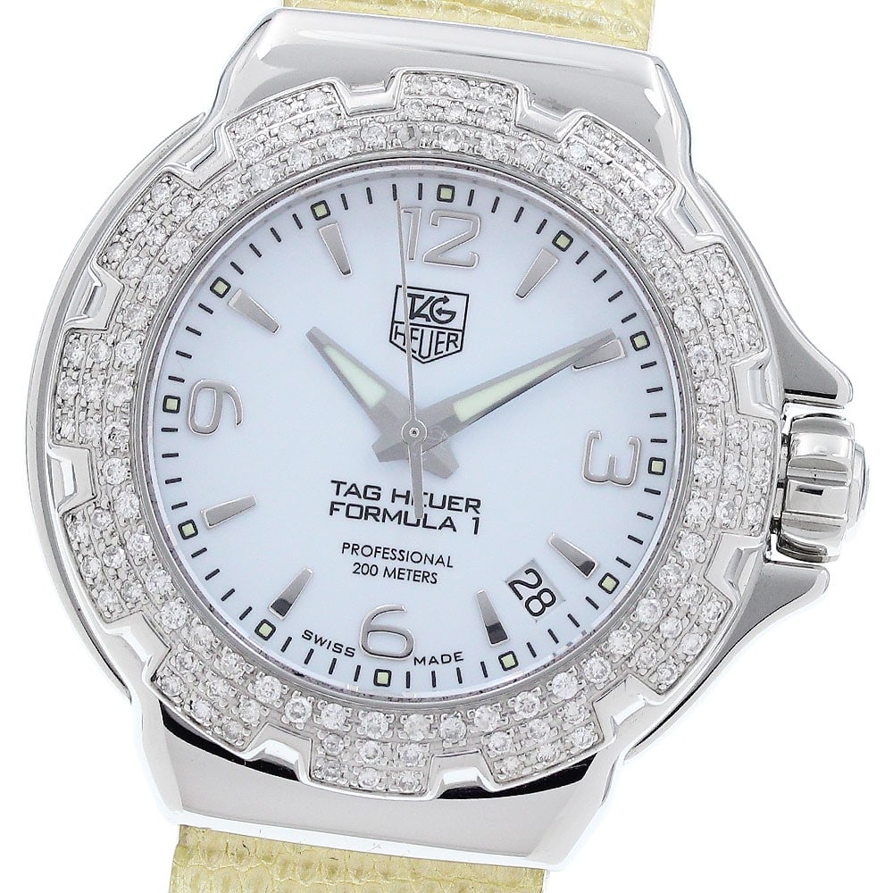 TAG Heuer Formula 1 WAC1215 quartz date ladies watch diamond bezel: TAG Heuer Formula 1 WAC1215 quartz date ladies watch diamond bezel This TAG Heuer Formula 1 women's wristwatch features a stainless steel case with a diamond bezel and a white dial. The watch is power