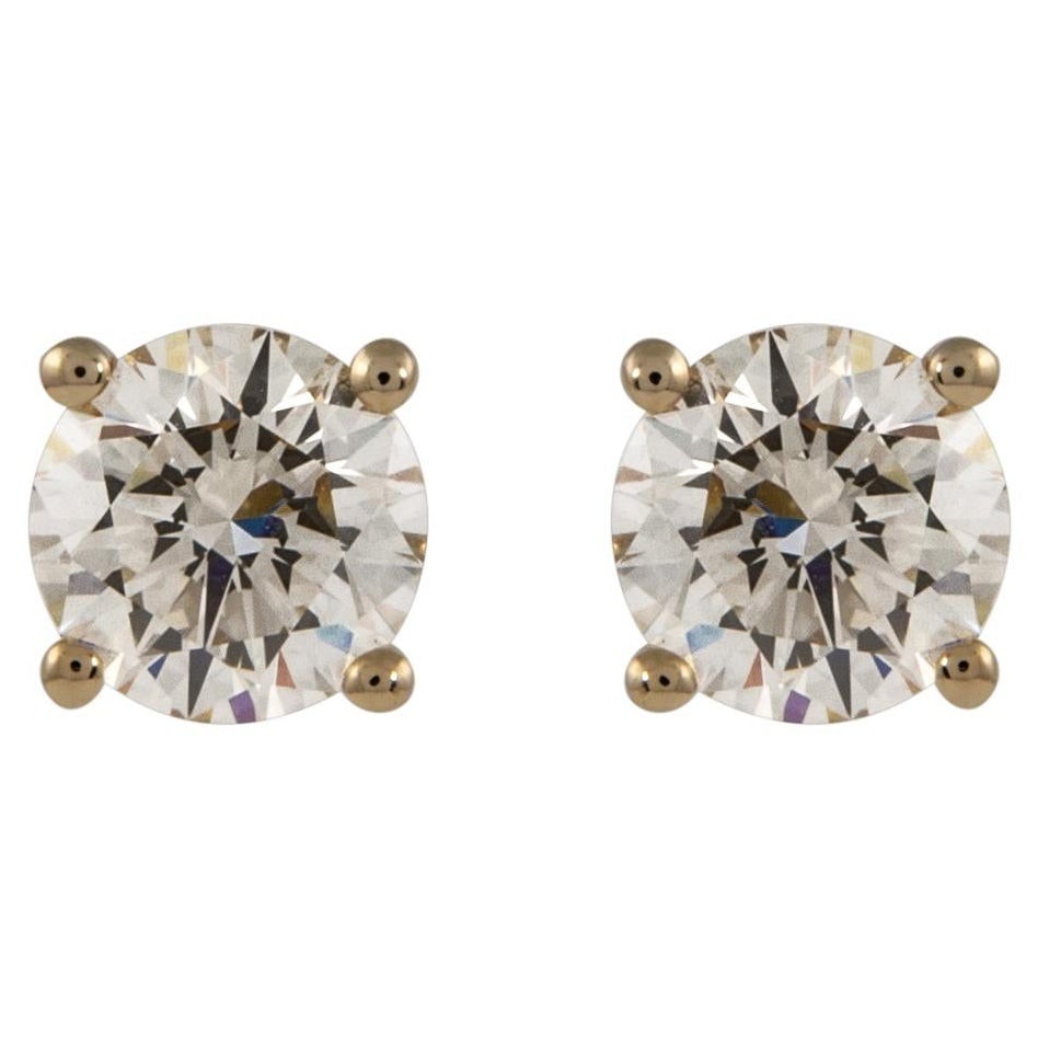2.02ct Round Diamond Stud Earrings in 14k Yellow Gold with GIA Appraisal: 2.02ct Round Diamond Stud Earrings in 14k Yellow Gold with GIA Appraisal These stunning 2.02ct round diamond stud earrings are crafted from 14k yellow gold, featuring two matching round brilliant diam