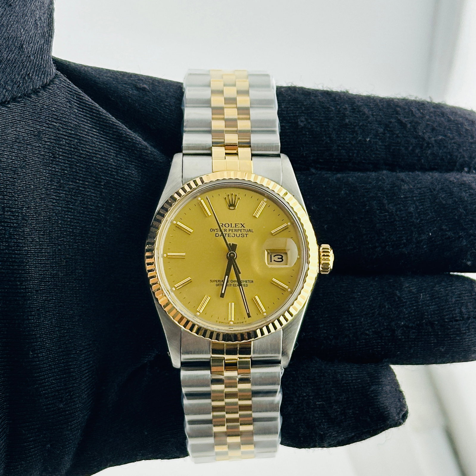 Rolex Datejust 16013 Champagne Stick Dial Aftermarket Jubilee Bracelet: Rolex Datejust 16013 Champagne Stick Dial Aftermarket Jubilee Bracelet This Rolex Datejust features a champagne stick dial and a fluted bezel, paired with an aftermarket Jubilee bracelet. The watch is