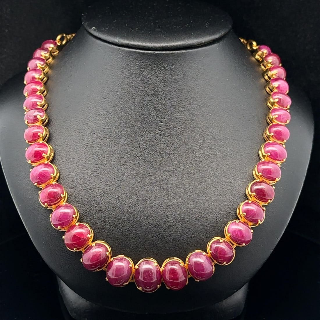 22k Yellow Gold Indian Necklace with Graduated Natural Ruby Cabochons Adjustable Length: 22k Yellow Gold Indian Necklace with Graduated Natural Ruby Cabochons Adjustable Length This vintage necklace features a graduated design with 31 natural genuine ruby cabochon stones, each prong set a