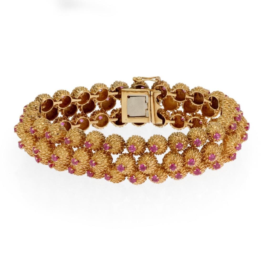 Etruscan Style 18k Yellow Gold Triple Row Ruby Bracelet: Etruscan Style 18k Yellow Gold Triple Row Ruby Bracelet This stunning estate bracelet is crafted from luxurious 18k yellow gold, showcasing an exquisite Etruscan style. The design features three rows 