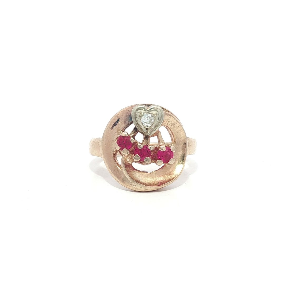 Vintage Retro 14k Rose Gold Ruby Diamond Heart Ring: Vintage Retro 14k Rose Gold Ruby Diamond Heart Ring This stunning vintage retro ring features a captivating heart design set on a circular open platter, crafted from solid 14k rose gold. The centerpie