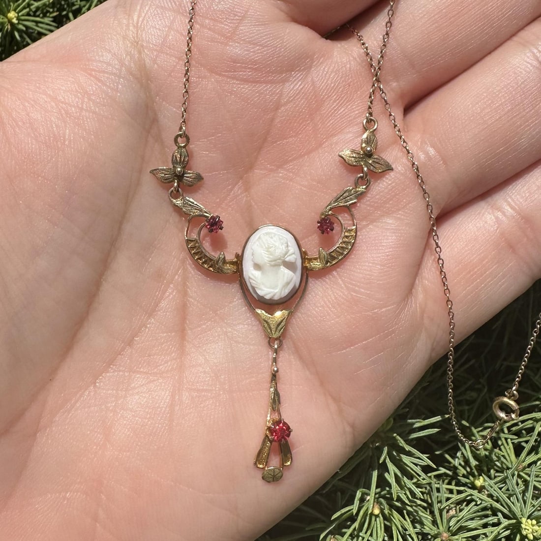 Antique 9-10k Yellow Gold Lavalier Necklace with Carved Cameo and Red Stones: Antique 9-10k Yellow Gold Lavalier Necklace with Carved Cameo and Red Stones Antique Art Nouveau lavalier necklace featuring a carved oval hardstone cameo with a light angel skin color, accented by th