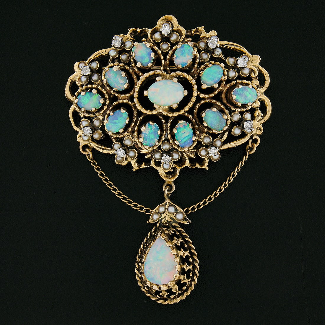 Vintage 14k Gold Opal Seed Pearl Diamond Dangle Brooch Pendant: Vintage 14k Gold Opal Seed Pearl Diamond Dangle Brooch Pendant This exquisite vintage brooch pendant features a stunning array of natural gemstones set in solid 14k yellow gold. The centerpiece is a b
