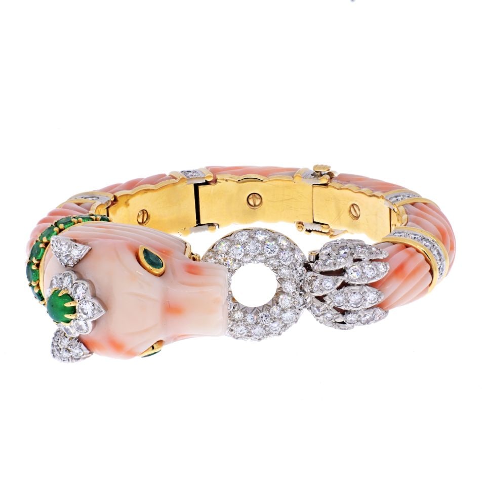 David Webb 18K Yellow Gold Angel Skin Coral Diamond Chimeral Bracelet: David Webb 18K Yellow Gold Angel Skin Coral Diamond Chimeral Bracelet This exquisite David Webb bracelet is a stunning piece of jewelry that beautifully combines mythology with artistry. Crafted from 