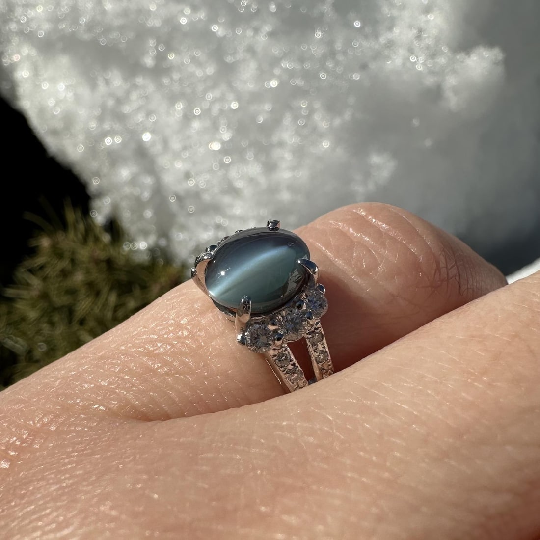 Platinum Split Shank Ring with Gray Cat's Eye and Diamond Accents 1.46ctw: Platinum Split Shank Ring with Gray Cat's Eye and Diamond Accents 1.46ctw This cocktail ring features a solid platinum split shank design set with a natural gray cat's eye gemstone in an oval cabochon