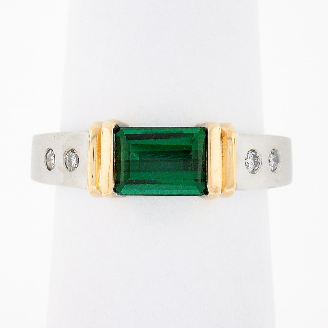 14k two tone tourmaline solitaire ring with diamond accents size 6: 14k two tone tourmaline solitaire ring with diamond accents size 6 This elegant band ring is crafted from solid 14k white gold with 14k yellow gold accents, featuring a rectangular step cut natural gr