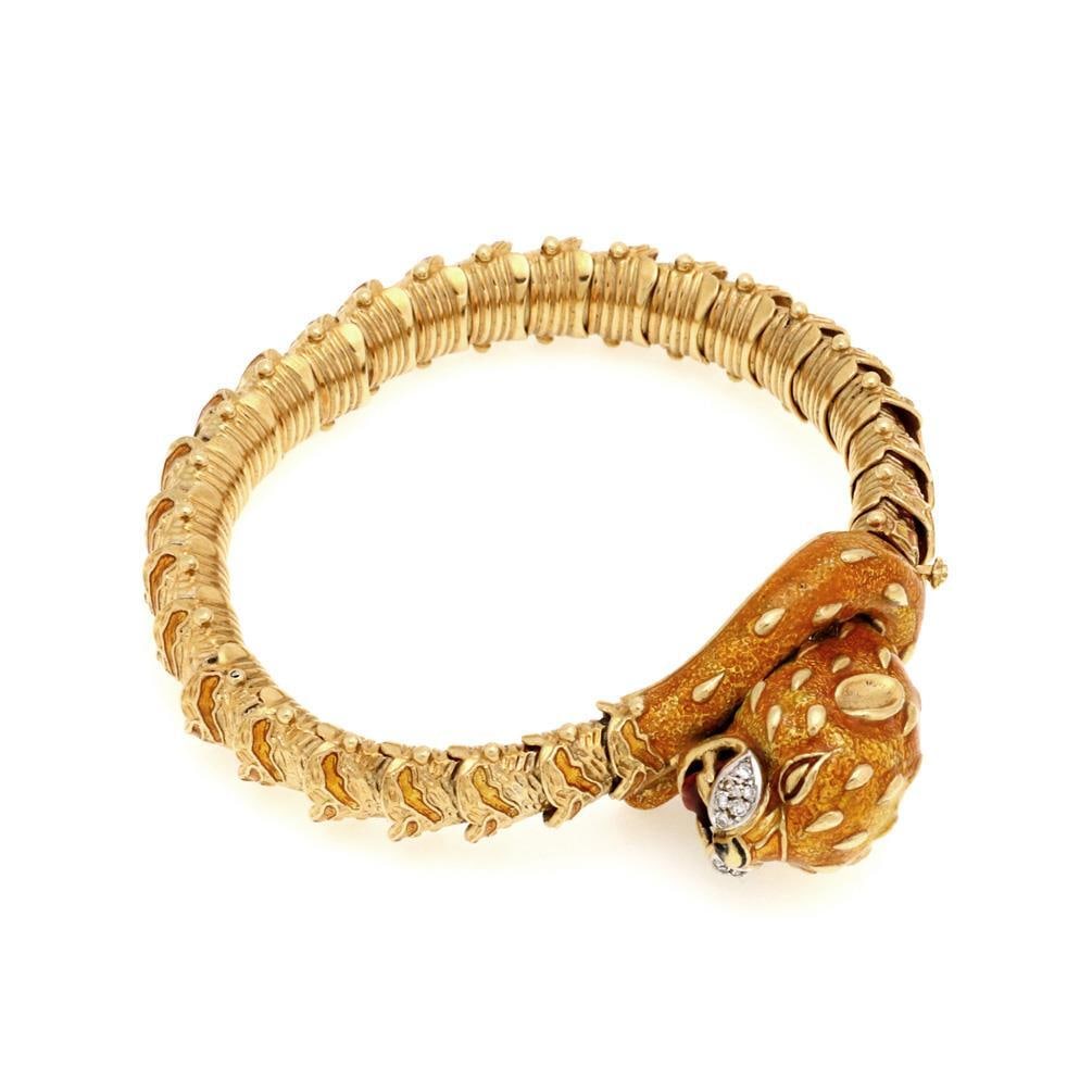 Estate 18k Yellow Gold Leopard Head Diamond Enamel Flex Bracelet: Estate 18k Yellow Gold Leopard Head Diamond Enamel Flex Bracelet This stunning estate bracelet showcases a 3D leopard's head crafted from 18k yellow gold, adorned with vibrant orange enamel. The flexi
