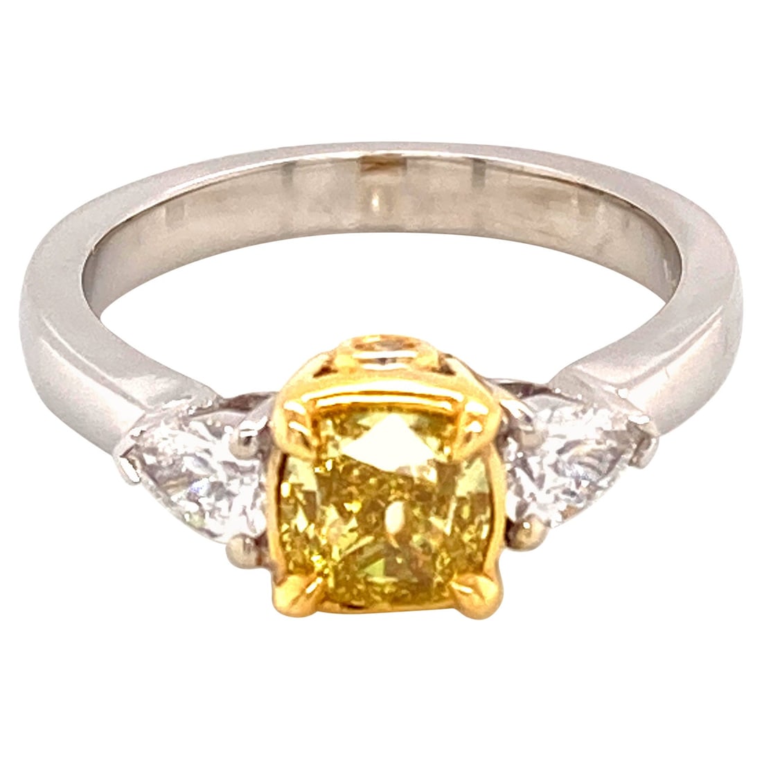GIA Certified Fancy Vivid Yellow Diamond Three Stone 1ct VS1 Ring: GIA Certified Fancy Vivid Yellow Diamond Three Stone 1ct VS1 Ring This stunning three stone ring features a GIA-certified 1.01 carat cushion-cut fancy vivid yellow diamond with VS1 clarity as the cent