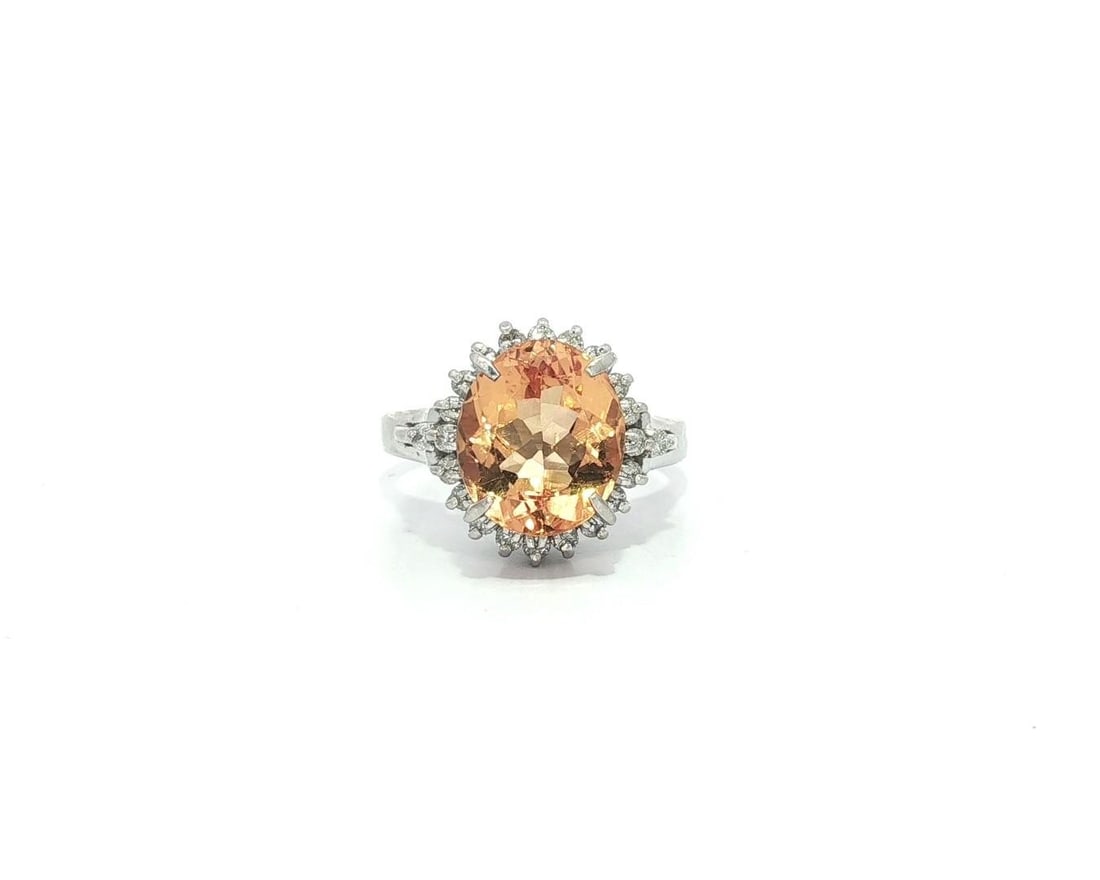 Platinum 3.46ctw Golden Orange Topaz Diamond Halo Cocktail Ring: Platinum 3.46ctw Golden Orange Topaz Diamond Halo Cocktail Ring Elevate your style with this stunning cocktail ring featuring a remarkable golden orange precious topaz at its center, surrounded by a h