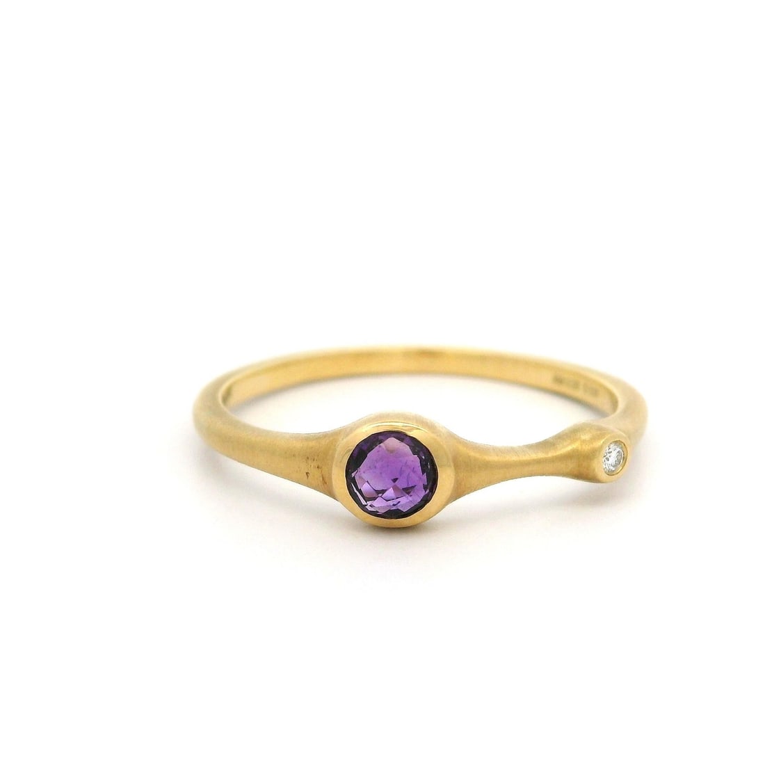Carelle 18k Gold Bezel Set Diamond Amethyst Band Ring 0.26ctw: Carelle 18k Gold Bezel Set Diamond Amethyst Band Ring 0.26ctw This exquisite band ring features a stunning combination of natural gemstones and solid 18k yellow gold. The centerpiece is a round, domed