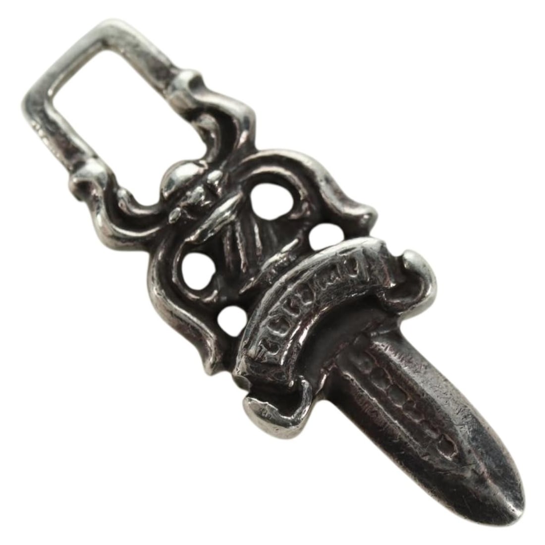 Chrome Hearts AG925 Silver Pendant Top Dagger Charm: Chrome Hearts AG925 Silver Pendant Top Dagger Charm Chrome Hearts dagger charm pendant top in silver. The piece is described as Ag925 silver and measures 1 cm wide by 3.5 cm high. Condition is heavily