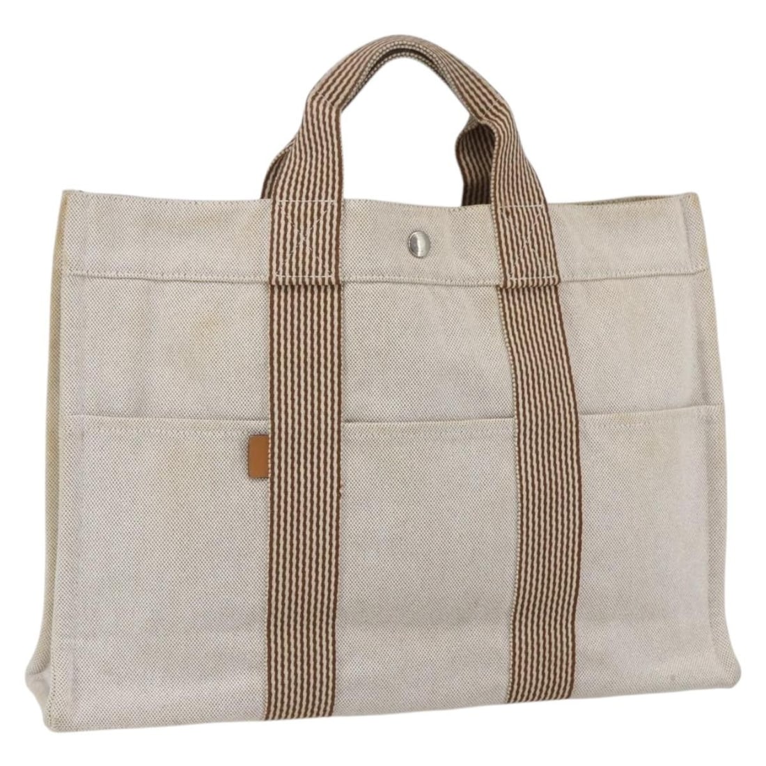Fourre Tout MM Canvas Tote Bag in Beige by Hermes France: Fourre Tout MM Canvas Tote Bag in Beige by Hermes France This Hermes Fourre Tout MM handbag is crafted from beige canvas and features dual handles. Made in France, it offers a spacious interior suitab