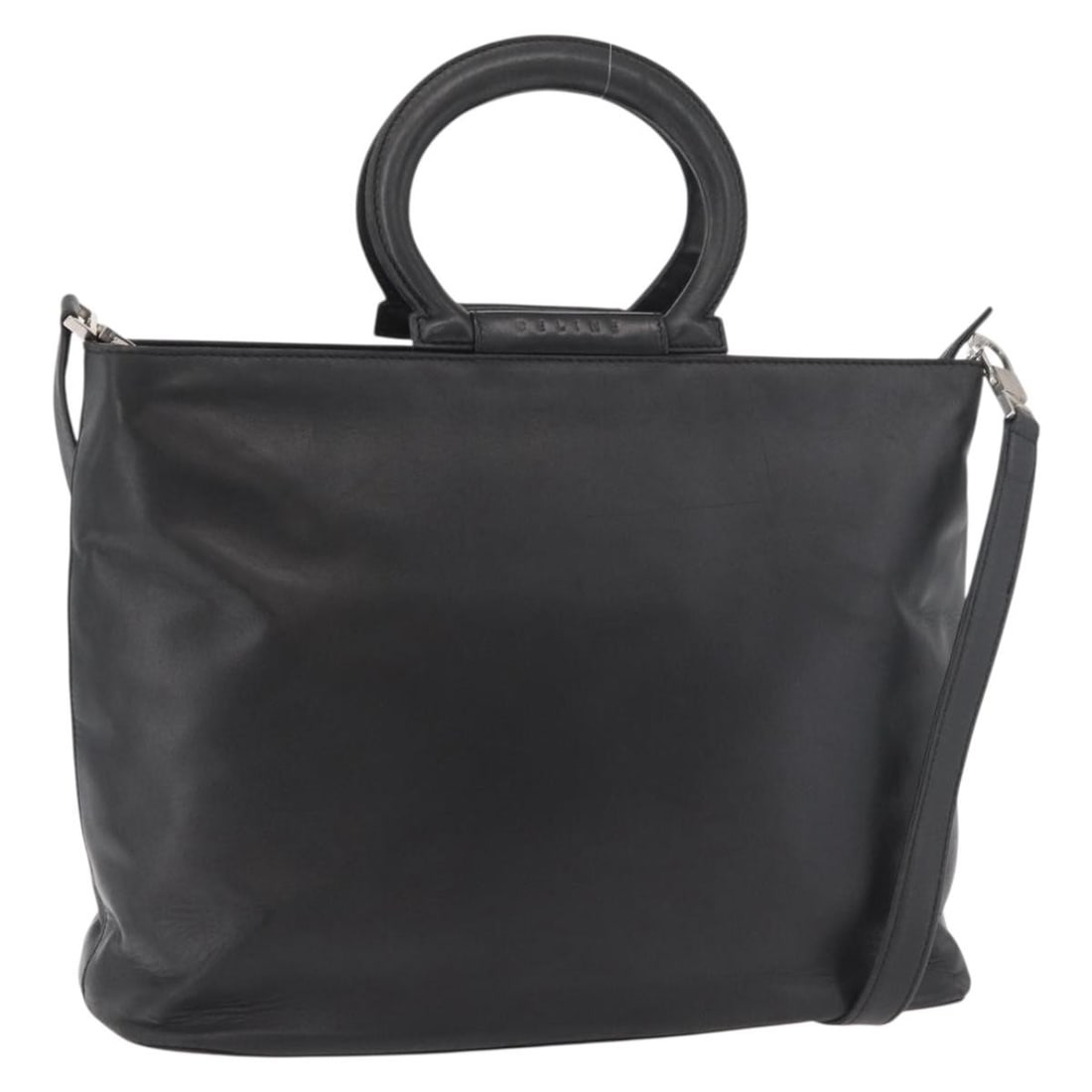Celine Black Leather 2 Way Handbag with Shoulder Strap: Celine Black Leather 2 Way Handbag with Shoulder Strap A CELINE 2-way leather handbag in black and gold, made in Spain. It comes with a shoulder strap and features a structured handbag style. The item