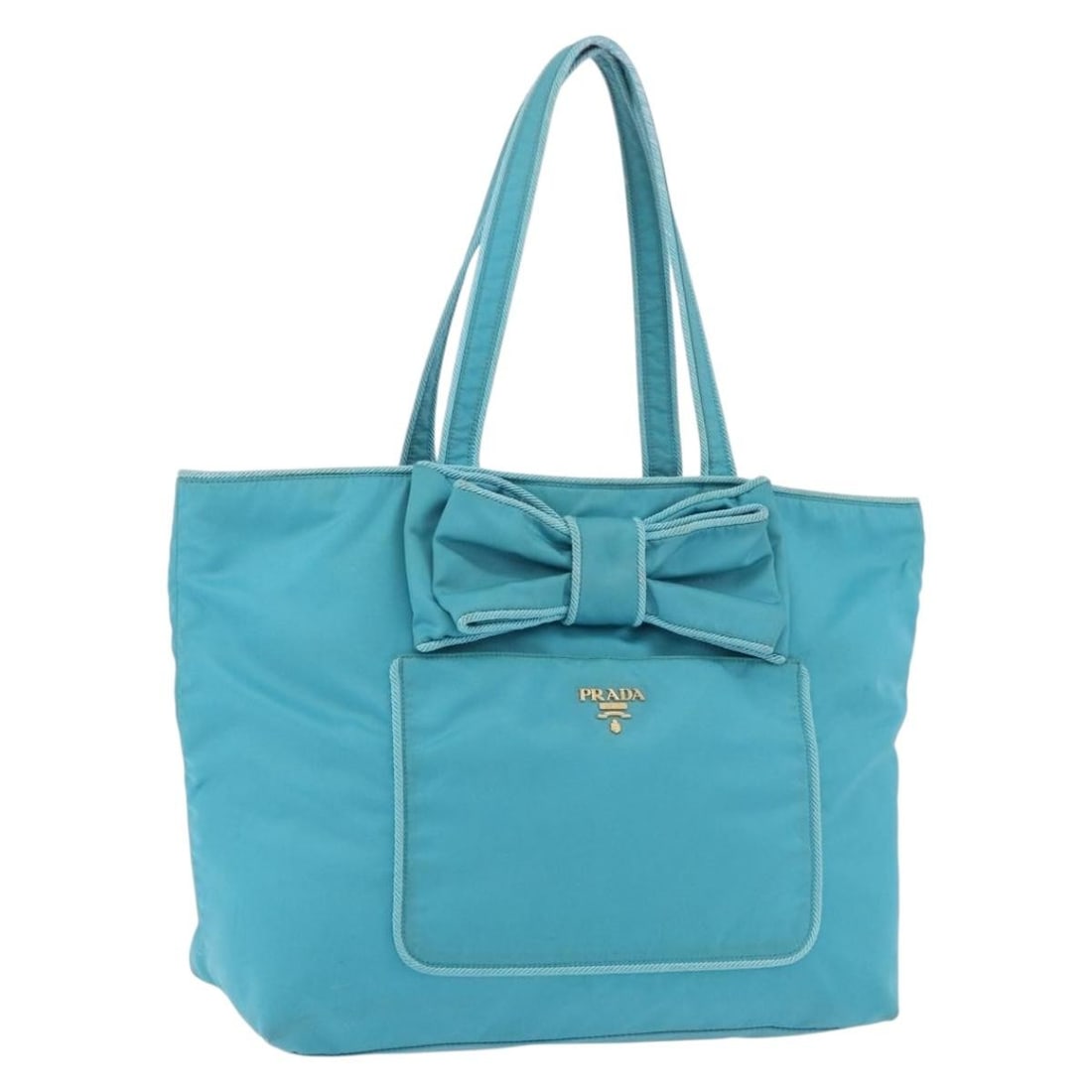 Prada Nylon Tote Handbag Turquoise Blue Gold Tone Italy: Prada Nylon Tote Handbag Turquoise Blue Gold Tone Italy A Prada tote bag in turquoise blue and gold, crafted from nylon and made in Italy. The bag measures approximately 34 cm W x 29 cm H x 15 cm D, w