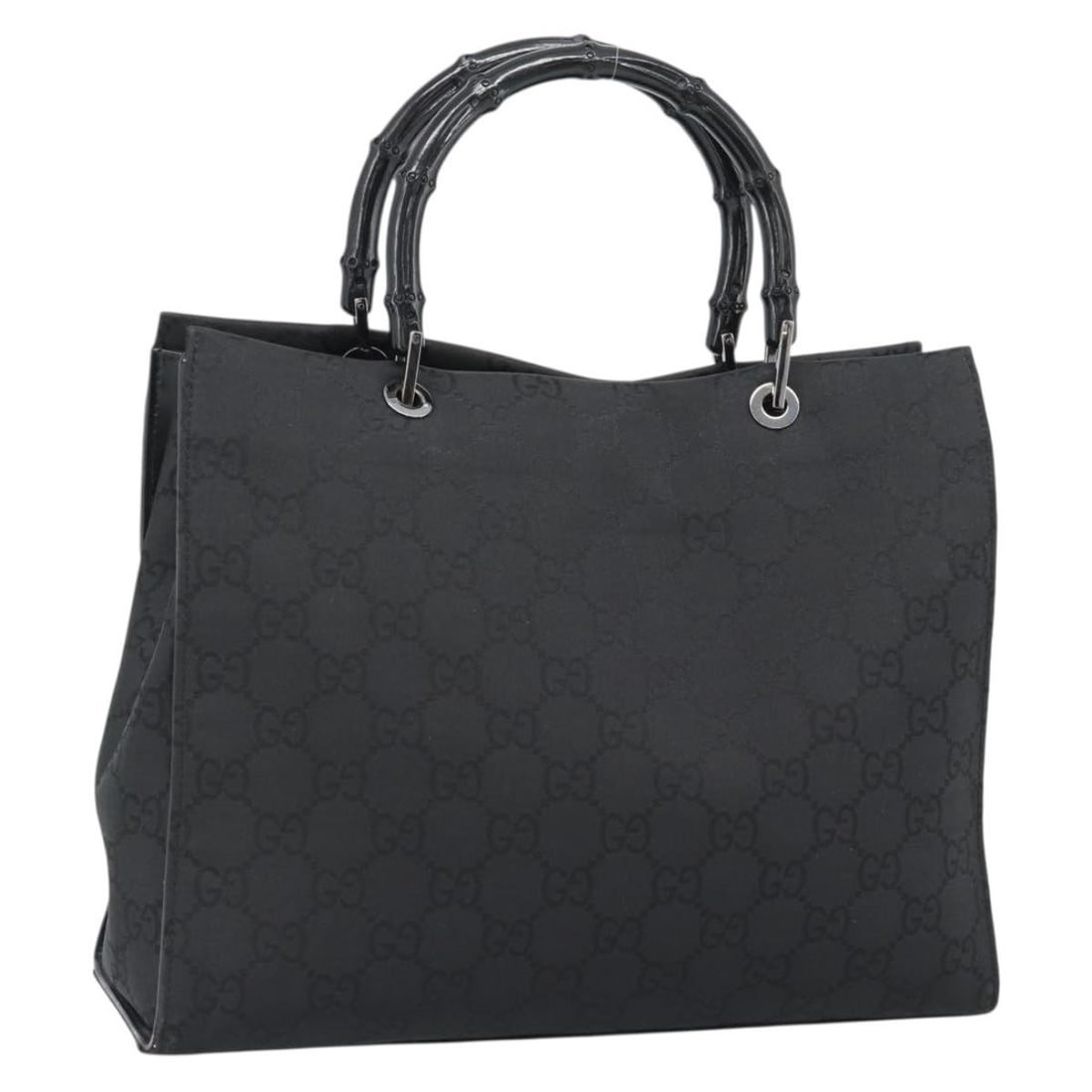 Gucci 002 1010 Bamboo Handle Handbag Black Nylon GG Canvas: Gucci 002 1010 Bamboo Handle Handbag Black Nylon GG Canvas This GUCCI hand bag is crafted in nylon and GG canvas with a black and silver color scheme. Made in Italy, it features a handle drop of appro