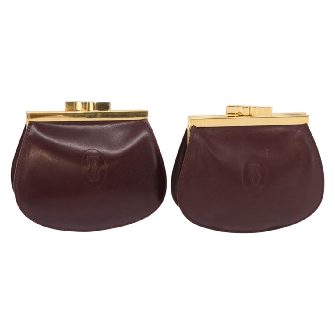 CARTIER Must Line Bordeaux Gold Leather Coin Purse Set of 2: CARTIER Must Line Bordeaux Gold Leather Coin Purse Set of 2 This exquisite CARTIER Must Line Coin Purse set features a luxurious bordeaux leather exterior adorned with gold accents. This stylish acces