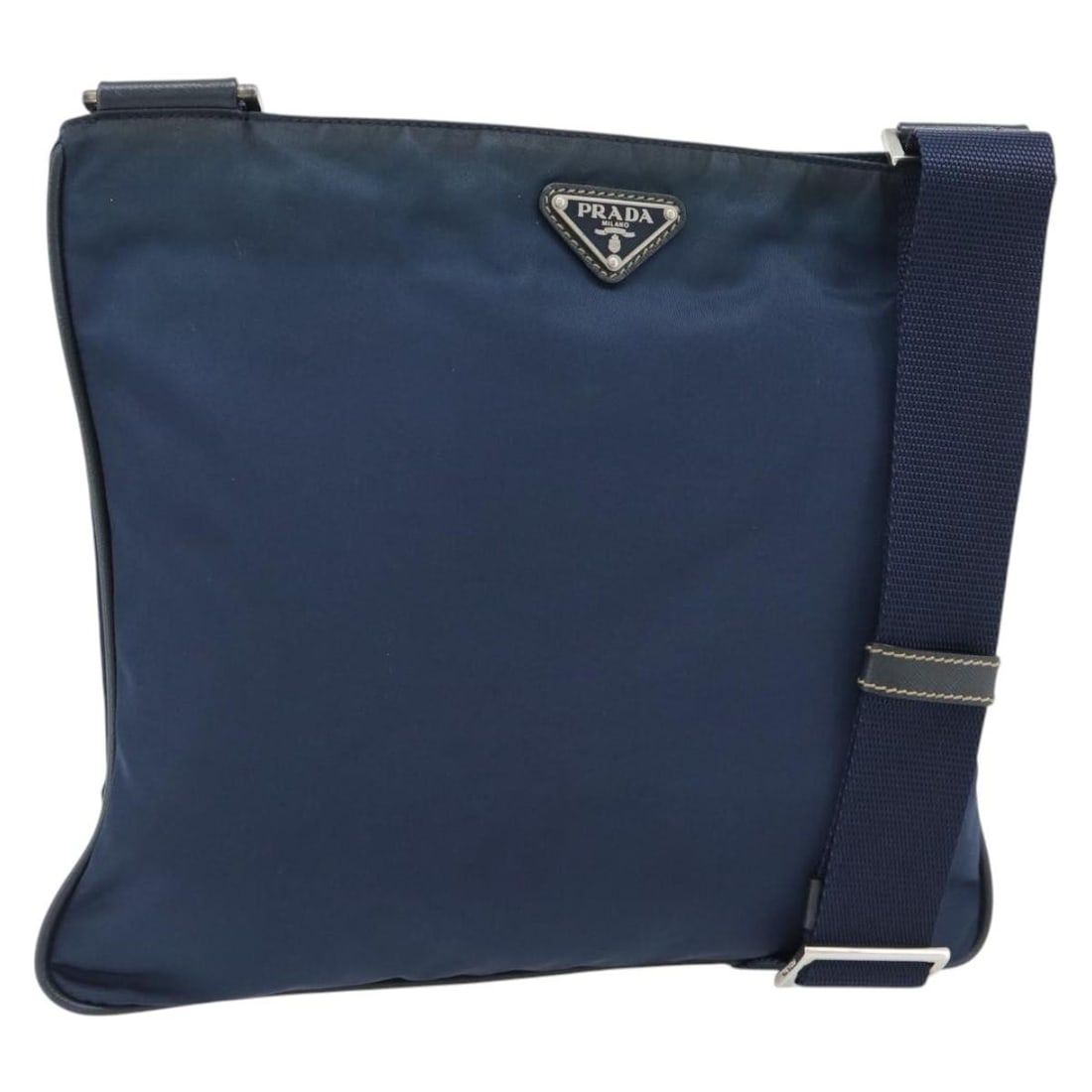 PRADA Nylon Shoulder Bag Navy Silver Tone Made in Italy: PRADA Nylon Shoulder Bag Navy Silver Tone Made in Italy Navy and silver Prada shoulder bag made of nylon, crafted in Italy. The bag measures approximately 30 cm wide by 26 cm high, with a shoulder dro