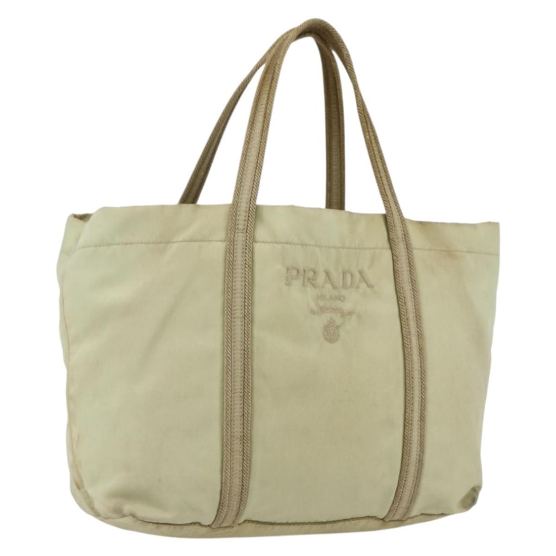 Cream and Silver Nylon Prada Handbag with Guarantee Card BS33166: Cream and Silver Nylon Prada Handbag with Guarantee Card BS33166 This Prada handbag features a cream nylon exterior with silver-tone metal fittings. It is crafted in Italy and includes a guarantee car