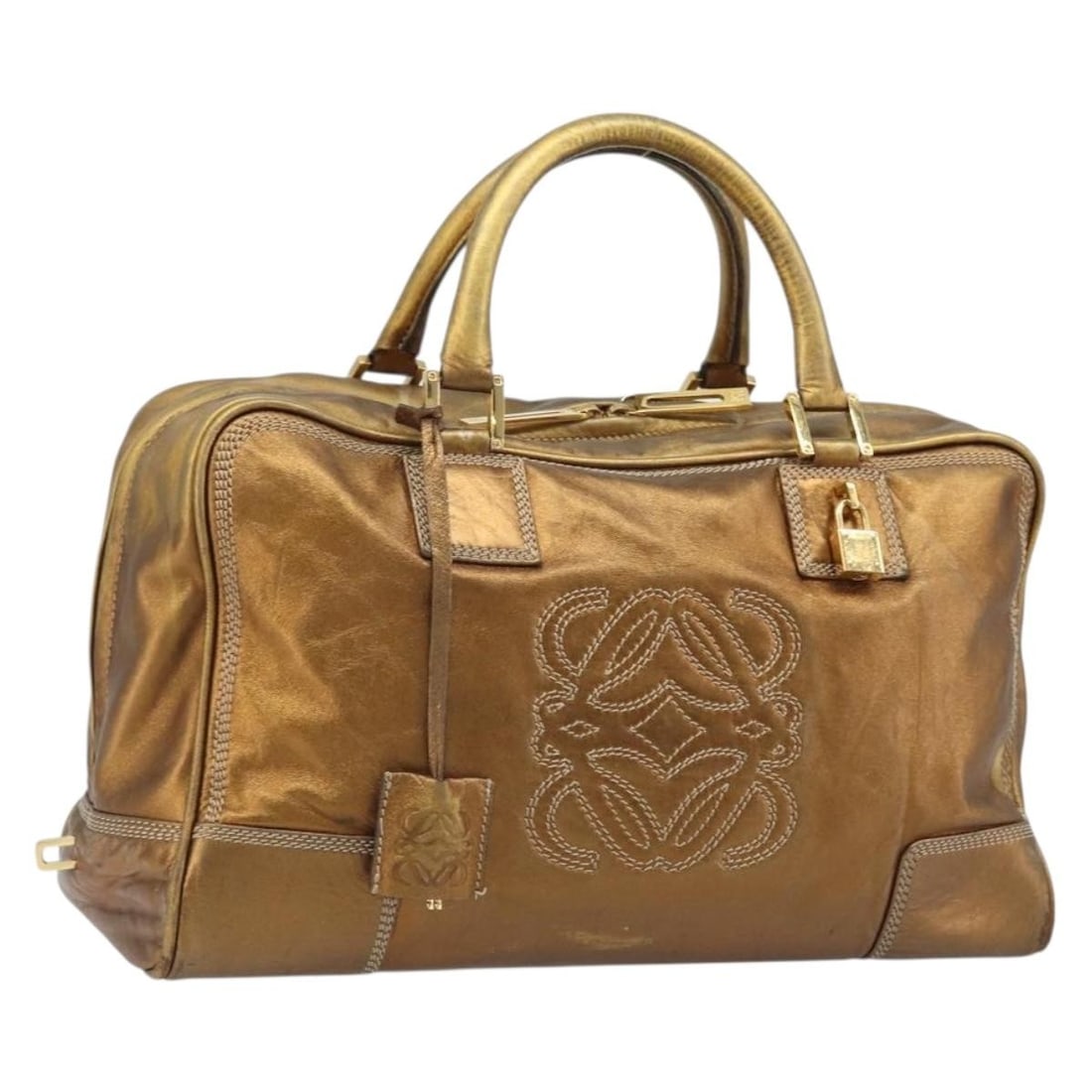 Loewe Amazona 36 Gold Tone Leather Handbag with Padlock and Keys: Loewe Amazona 36 Gold Tone Leather Handbag with Padlock and Keys This LOEWE Anagram Amazona 36 handbag features a gold tone leather exterior and is designed for women. The bag includes a padlock, two 