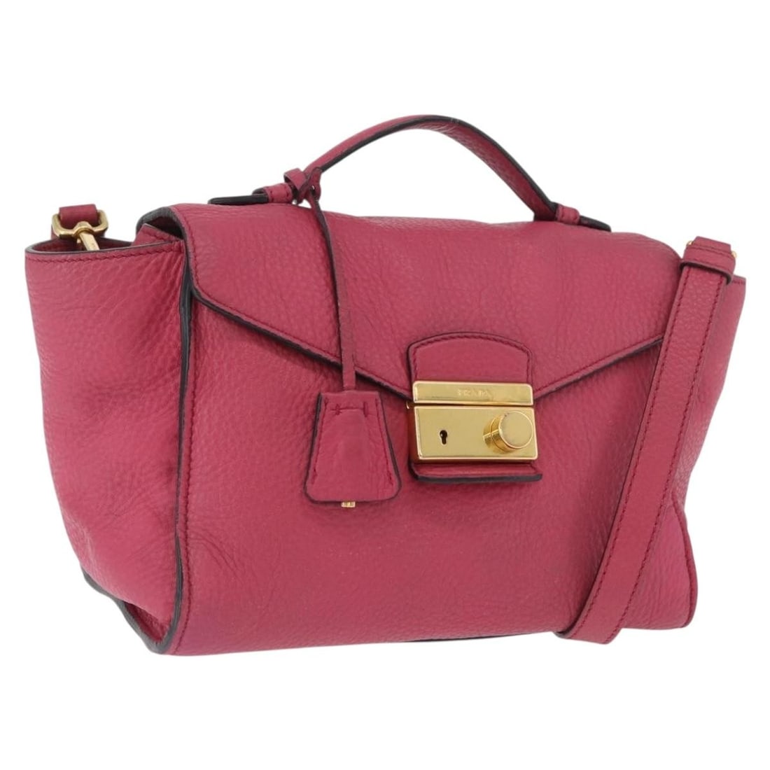 Prada Pink Leather Two Way Handbag with Shoulder Strap and Clochette: Prada Pink Leather Two Way Handbag with Shoulder Strap and Clochette This Prada handbag is crafted from leather in a pink and gold color combination. Designed for women, it features both top handles a