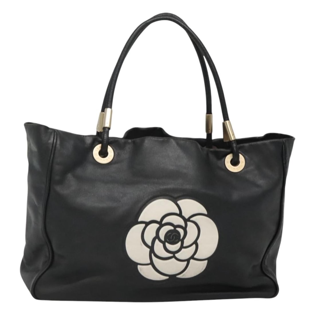 Black Lamb Skin Tote Bag CHANEL Camelia CC France: Black Lamb Skin Tote Bag CHANEL Camelia CC France A Chanel Camelia tote bag in black lamb skin, made in France. This pre-owned bag is offered in heavily used condition with visible wear throughout, in