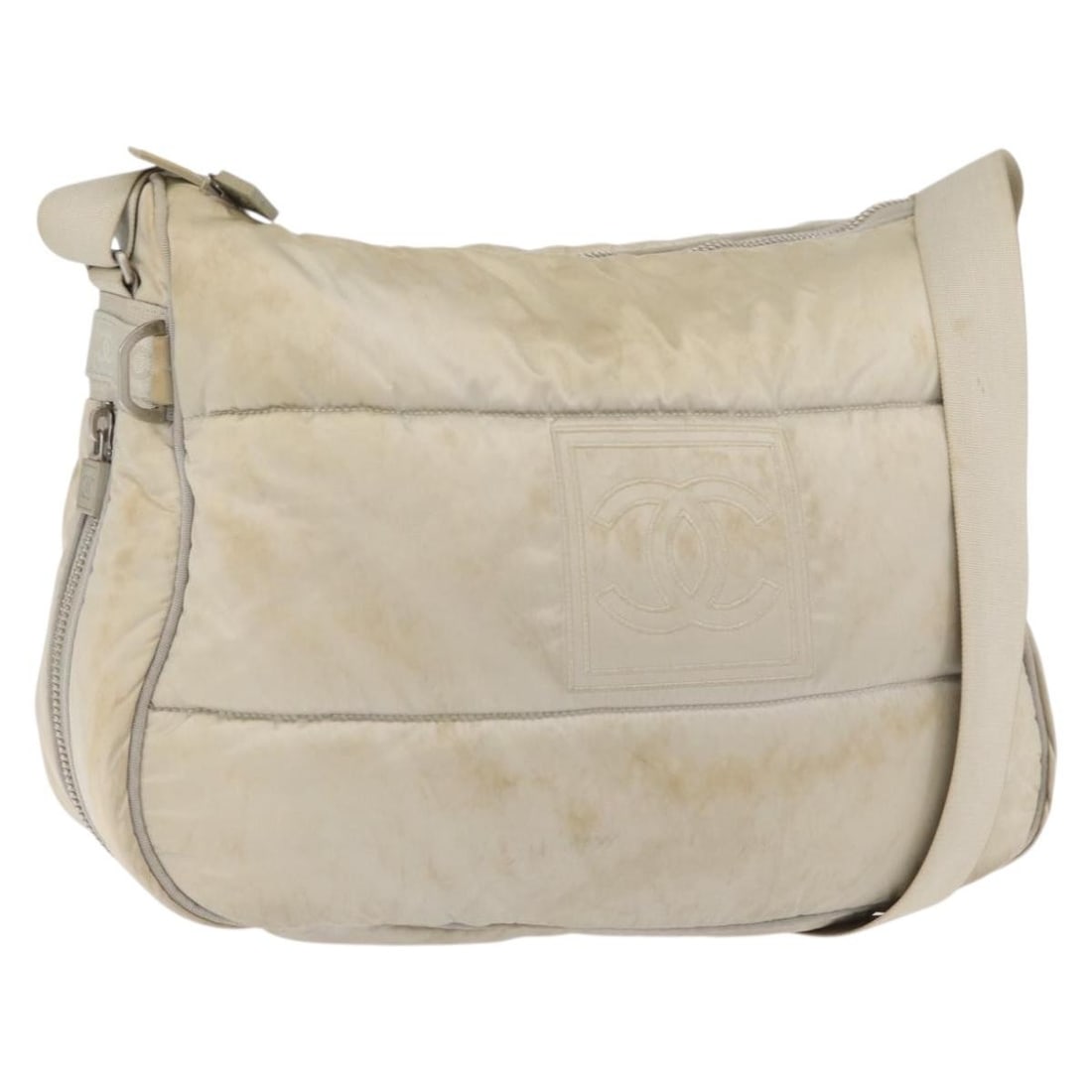Beige Nylon CHANEL CC Shoulder Bag Silver Tone: Beige Nylon CHANEL CC Shoulder Bag Silver Tone Beige and silver Chanel shoulder bag made of nylon, crafted in Italy. The bag measures approximately 38 cm wide, 25 cm high, and 10 cm deep, with a shoul
