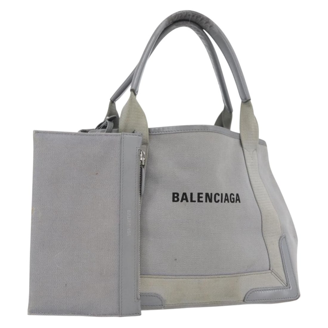 Balenciaga gray silver canvas tote with pouch 339933: Balenciaga gray silver canvas tote with pouch 339933 This BALENCIAGA tote bag is crafted from gray and silver canvas with leather accents, featuring a spacious interior and a practical design. Made in