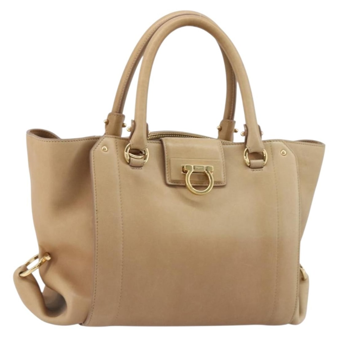 Leather Gancini Handbag by Salvatore Ferragamo Beige Gold Tone: Leather Gancini Handbag by Salvatore Ferragamo Beige Gold Tone Salvatore Ferragamo Gancini hand bag in beige and gold leather, made in Italy. The bag measures approximately 24 cm W x 22 cm H x 17 cm D