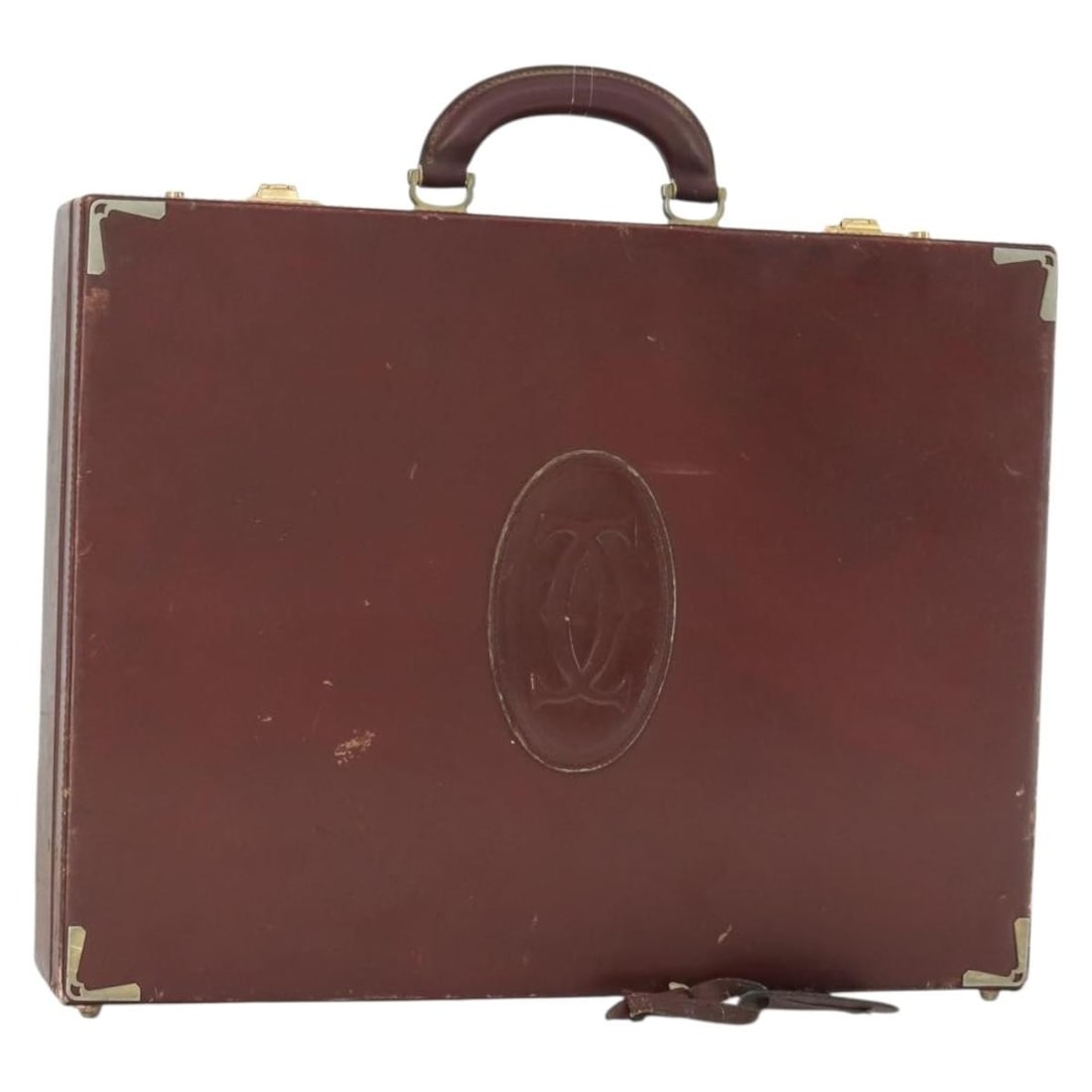Cartier Bordeaux Leather Trunk Bag with Name Tag: Cartier Bordeaux Leather Trunk Bag with Name Tag This Cartier Must Line trunk is crafted from Bordeaux leather with gold-tone accents. Made in Italy, it features a structured design with a top handle 