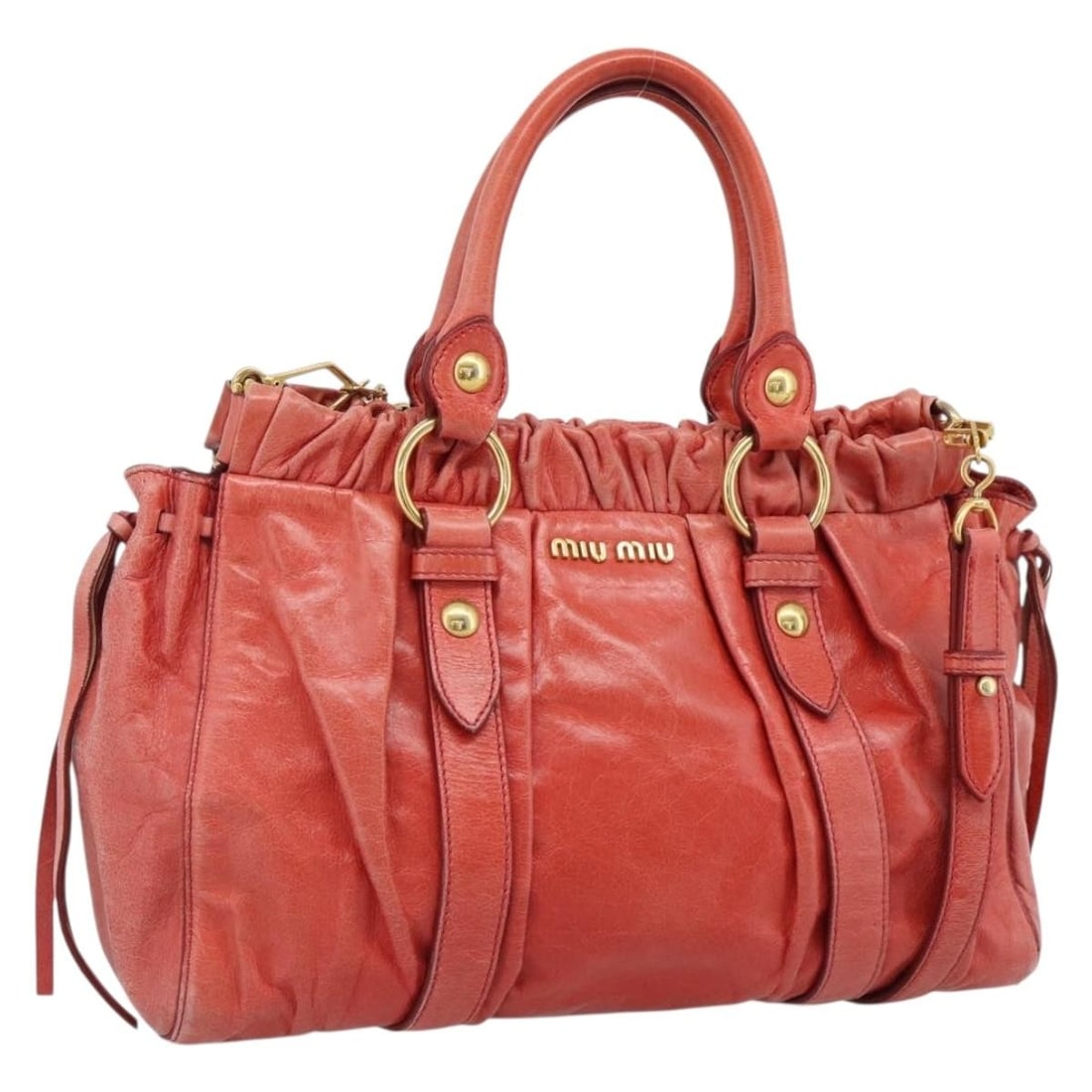 Miu Miu Leather 2way Hand Bag Orange Gold with Shoulder Strap: Miu Miu Leather 2way Hand Bag Orange Gold with Shoulder Strap Miu Miu side ribbon hand bag in leather, presented in orange and gold. This women's bag is a 2-way style and includes a shoulder strap. It