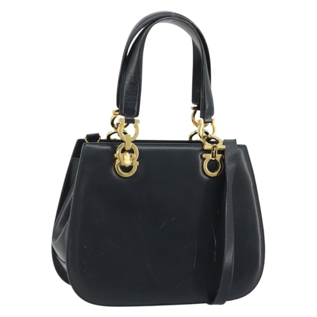 Ferragamo Gancini Navy Leather Convertible Handbag with Gold Hardware: Ferragamo Gancini Navy Leather Convertible Handbag with Gold Hardware This Salvatore Ferragamo Gancini handbag offers versatile 2-way styling and is crafted from navy leather with gold-tone accents. D