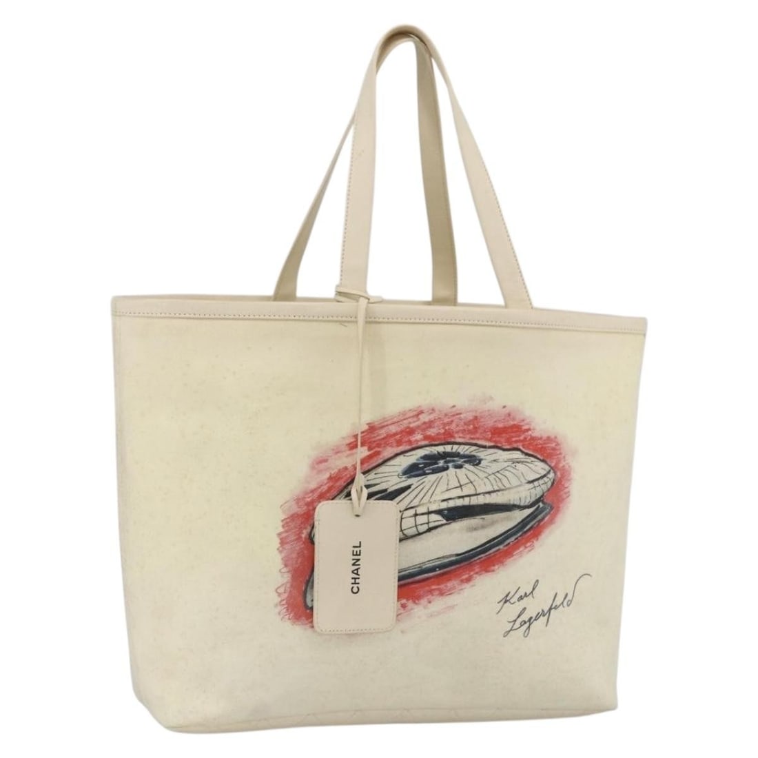 White and Silver Canvas Leather Tote by CHANEL with CC Logo: White and Silver Canvas Leather Tote by CHANEL with CC Logo This CHANEL tote bag features a white and silver canvas exterior with leather accents. Designed for women, the bag offers ample space and a 