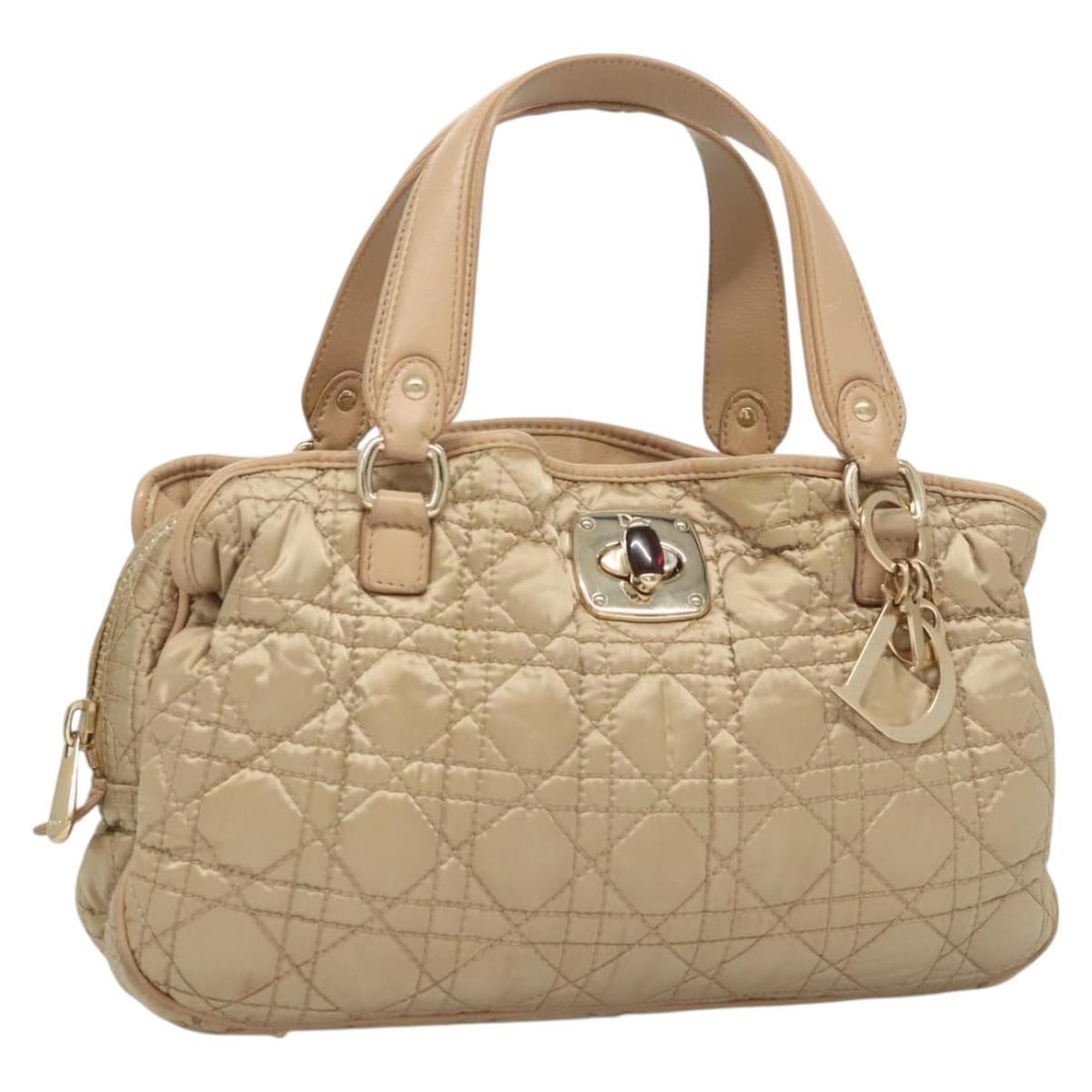 Christian Dior Beige Gold Nylon Canage Handbag Charm Italy: Christian Dior Beige Gold Nylon Canage Handbag Charm Italy This Christian Dior Canage handbag is crafted from beige and gold nylon and features a classic, structured silhouette. The bag includes a cha