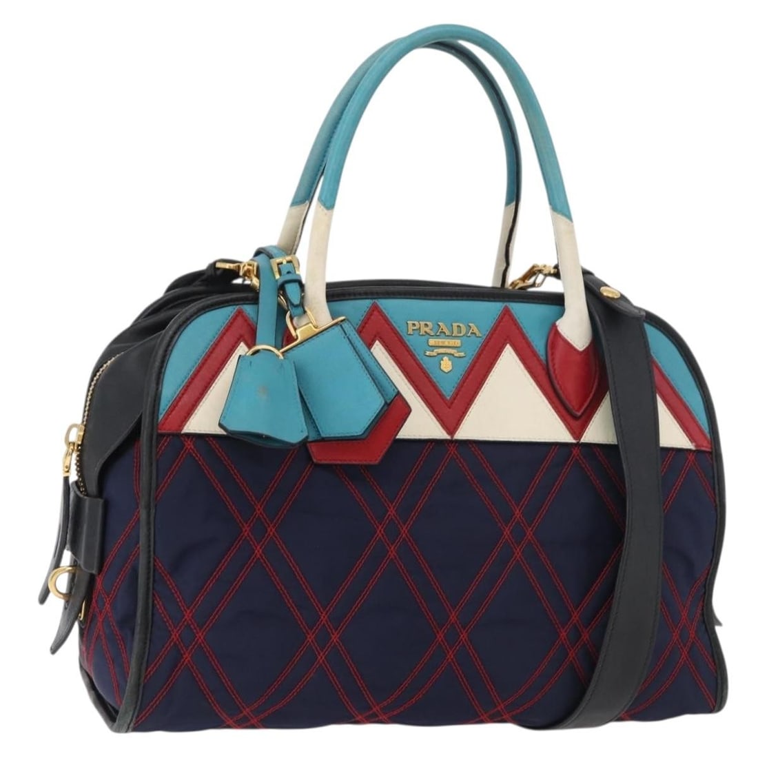 Prada navy gold leather quilted handbag with strap and padlock: Prada navy gold leather quilted handbag with strap and padlock This PRADA Graphic Quilt handbag features a sophisticated navy and gold color combination and is crafted from leather. Designed for versa