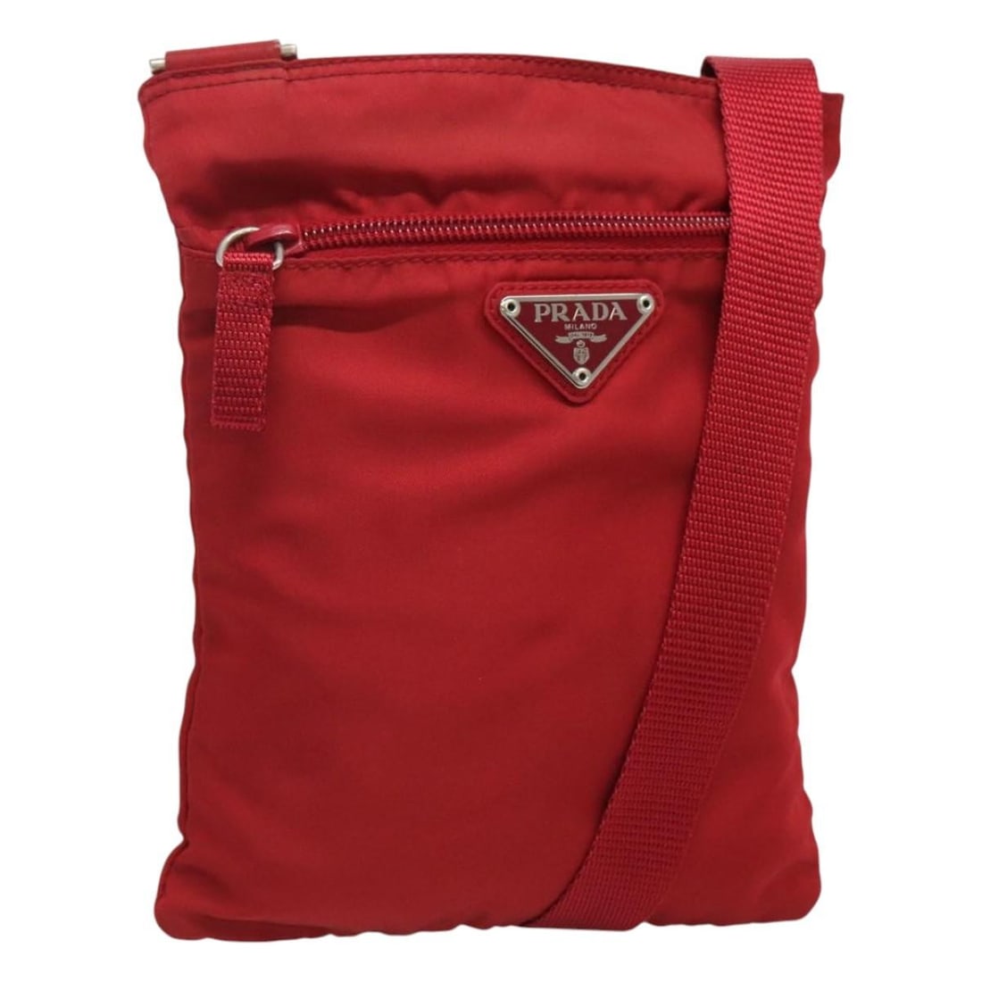 Prada Red Nylon Shoulder Bag with Silver Tone Accents Italy: Prada Red Nylon Shoulder Bag with Silver Tone Accents Italy This PRADA shoulder bag features a red nylon exterior with silver-tone accents. Designed for women, the bag offers a compact size and adjust