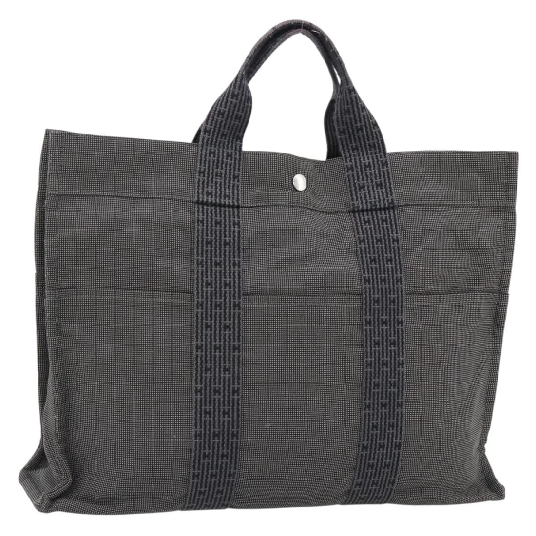 Hermes Her Line MM Gray Canvas Hand Bag Silver Tone: Hermes Her Line MM Gray Canvas Hand Bag Silver Tone Hermes Her Line MM hand bag in gray/silver canvas, made in France. The item is a heavily used pre-owned handbag and is offered as the bag only; no i