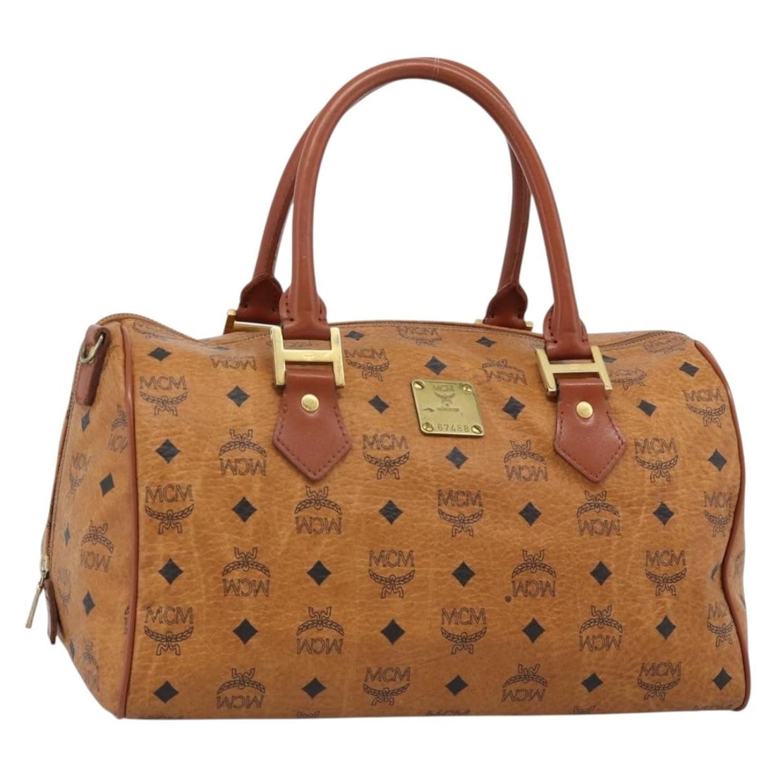 MCM Boston Bag Brown Gold PVC Leather Handbag: MCM Boston Bag Brown Gold PVC Leather Handbag This MCM Boston bag features the brand's logogram design in PVC leather with a brown and gold color scheme. It is a women's bag made in Germany and is off