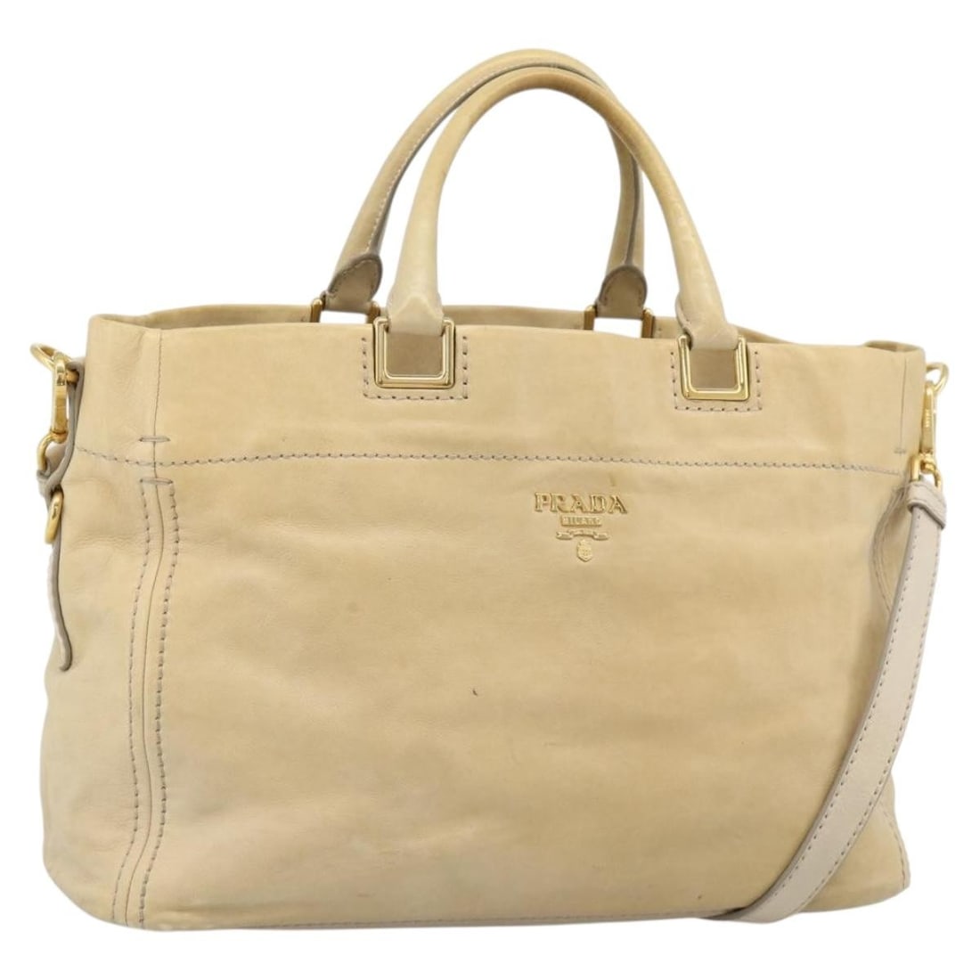 Prada Beige Leather 2 Way Handbag with Shoulder Strap: Prada Beige Leather 2 Way Handbag with Shoulder Strap Beige Prada 2-way handbag crafted in leather and made in Italy. It comes with a shoulder strap and features gold-tone metal fittings. The bag is r