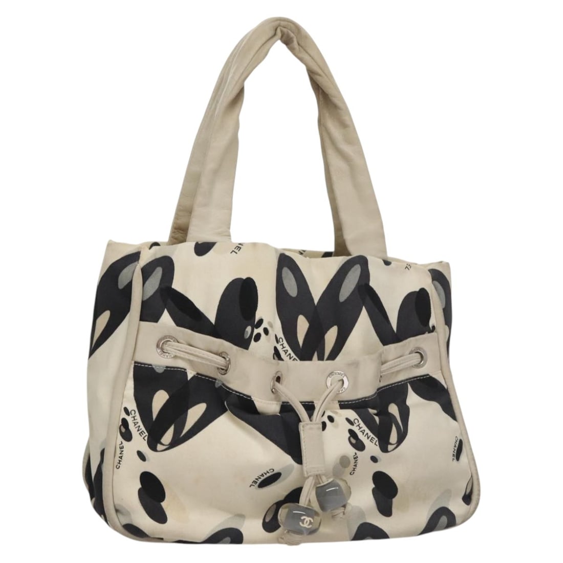 CHANEL White Black Canvas Tote Bag Silver CC Logo Italy: CHANEL White Black Canvas Tote Bag Silver CC Logo Italy This CHANEL tote bag is crafted from canvas in a stylish white, black, and silver color combination. Designed for women, the bag features a spac
